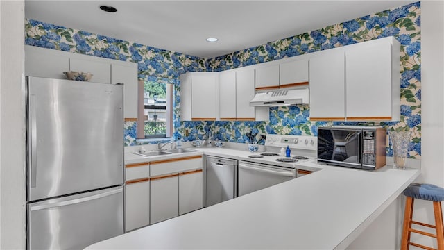 kitchen featuring white cabinetry, stainless steel appliances, and sink