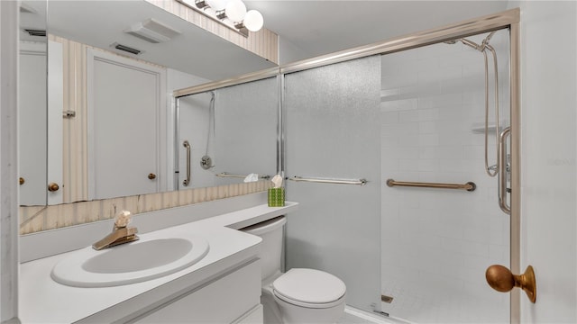 bathroom with vanity, toilet, and an enclosed shower