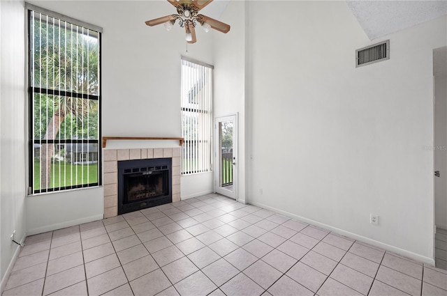 unfurnished living room featuring light tile patterned floors, plenty of natural light, and ceiling fan