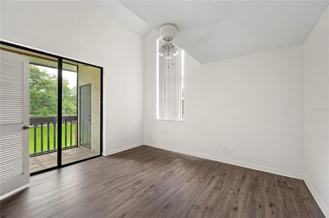 empty room featuring a textured ceiling and hardwood / wood-style flooring