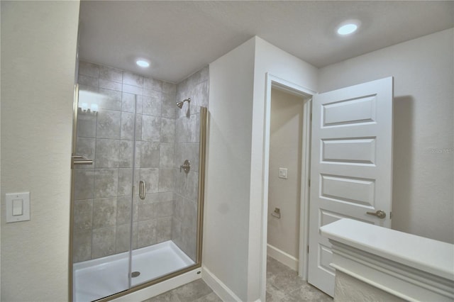 bathroom with a shower with door