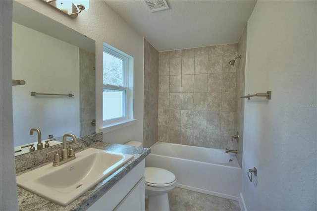 full bathroom with vanity, toilet, plenty of natural light, and tiled shower / bath combo