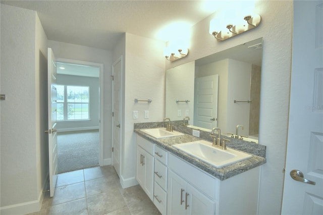 bathroom with tile patterned floors and vanity