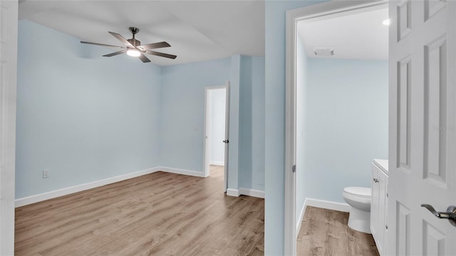 bathroom with ceiling fan, hardwood / wood-style flooring, and toilet