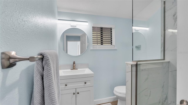 bathroom with vanity, toilet, and a shower with shower door