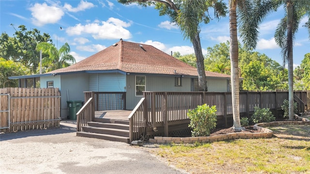 back of property with a wooden deck