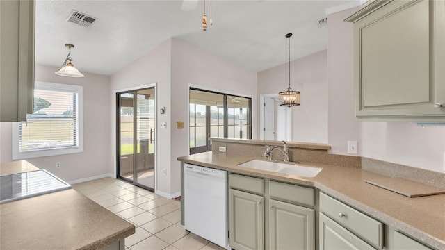 kitchen with sink, light tile patterned floors, decorative light fixtures, dishwasher, and lofted ceiling