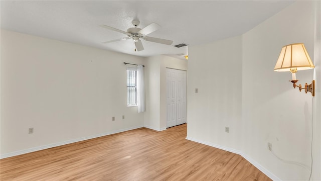 unfurnished room with light hardwood / wood-style floors and ceiling fan