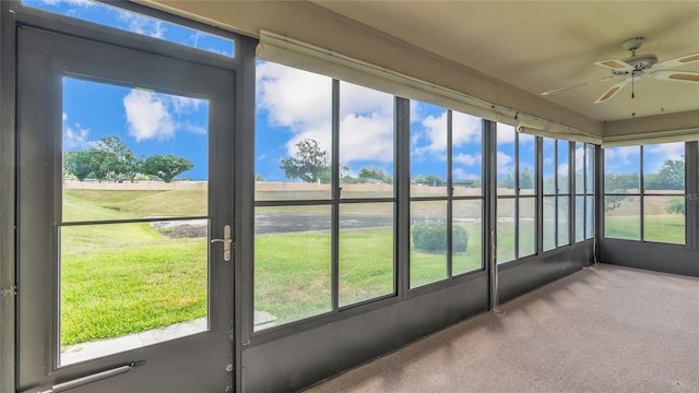 unfurnished sunroom with plenty of natural light and ceiling fan