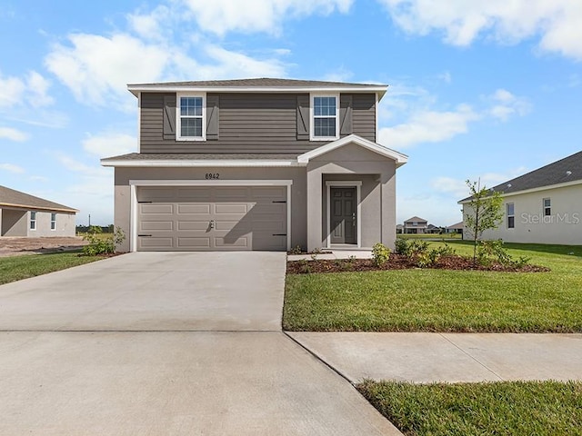 view of front property featuring a front yard and a garage