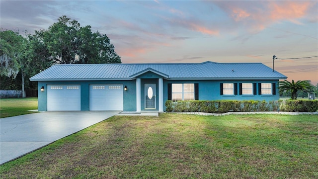 single story home with a lawn and a garage