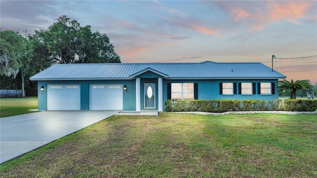 6110 Downing St, Dover, FL 33527 - ranch-style home with stucco siding, an attached garage, driveway, a front yard, and a metal roof