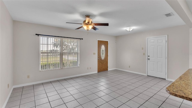 entryway featuring ceiling fan and light tile patterned floors