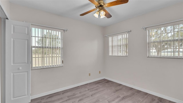 spare room with light hardwood / wood-style flooring, plenty of natural light, and ceiling fan