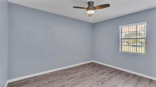 spare room with ceiling fan and light hardwood / wood-style flooring