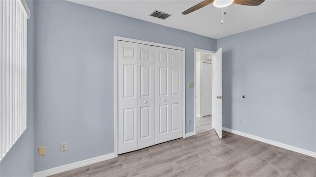 unfurnished bedroom featuring a closet, ceiling fan, and light hardwood / wood-style flooring