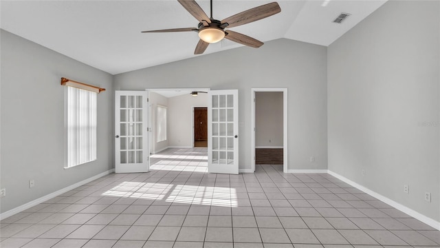 spare room featuring ceiling fan, lofted ceiling, light tile patterned floors, and french doors