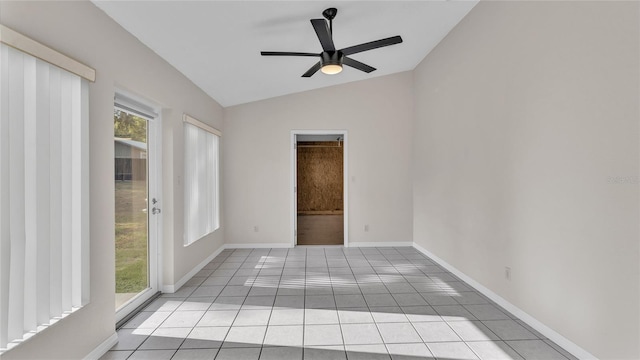 spare room with plenty of natural light, ceiling fan, light tile patterned floors, and vaulted ceiling