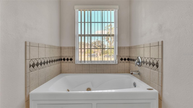 6110 Downing St, Dover, FL 33527 - full bath featuring a whirlpool tub, healthy amount of natural light, and a textured wall
