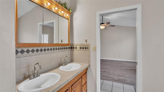 bathroom featuring vanity, hardwood / wood-style flooring, ceiling fan, and lofted ceiling