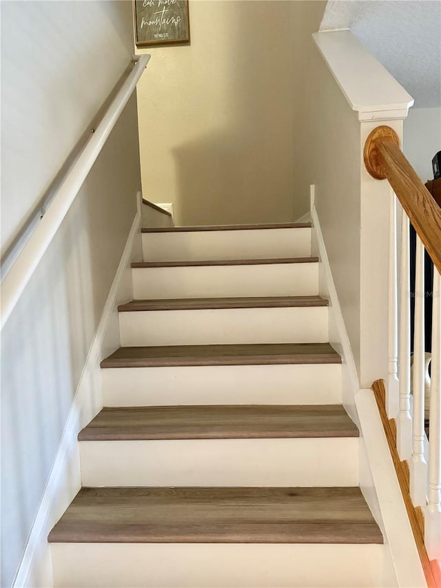 staircase with wood-type flooring