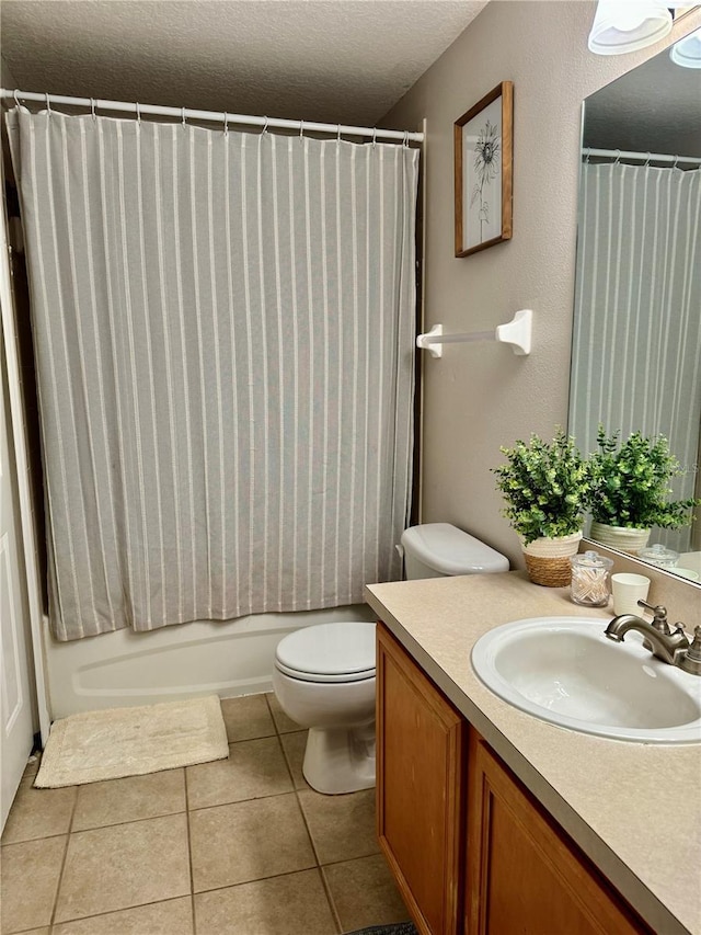 full bathroom with vanity, tile patterned floors, toilet, a textured ceiling, and shower / tub combo with curtain