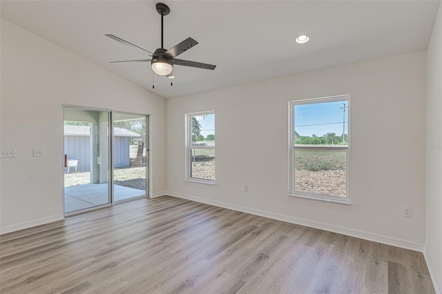 spare room featuring light hardwood / wood-style flooring, ceiling fan, and lofted ceiling