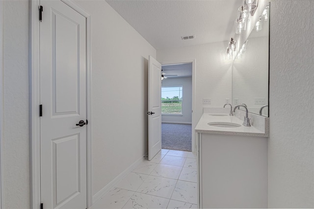 bathroom with vanity and a textured ceiling