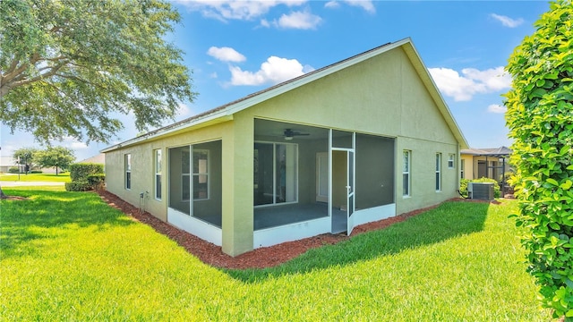 view of side of property featuring central AC, a sunroom, and a lawn