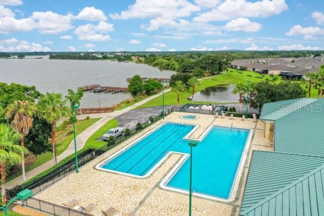 view of pool with a patio area and a water view