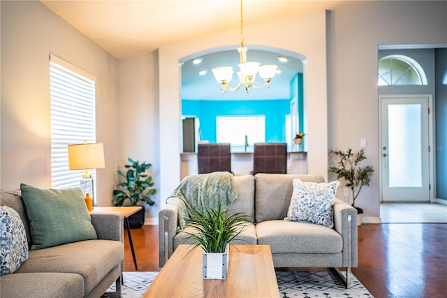 living room featuring plenty of natural light and a notable chandelier