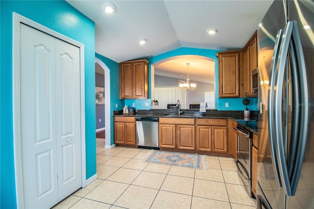 kitchen with decorative light fixtures, sink, light tile patterned floors, and stainless steel appliances