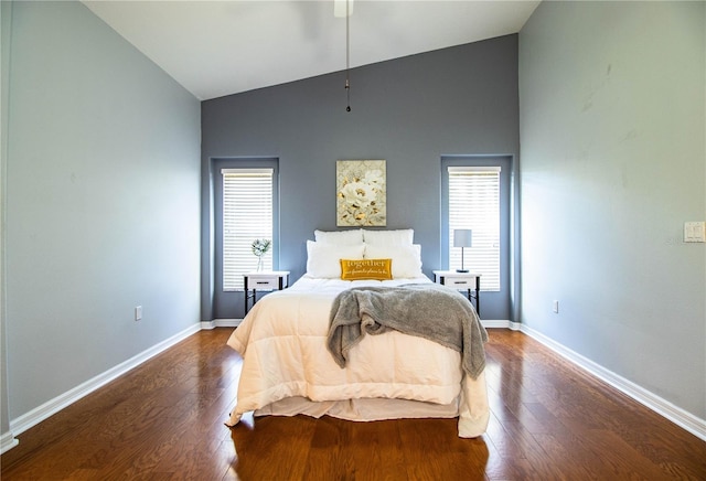 bedroom featuring hardwood / wood-style flooring and high vaulted ceiling