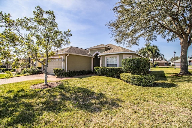 view of front of home featuring a garage and a front yard