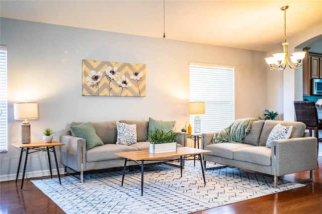 living room featuring hardwood / wood-style flooring, a wealth of natural light, and a notable chandelier