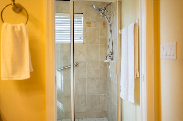 bathroom featuring a shower with door