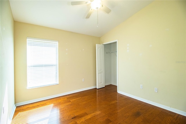 unfurnished bedroom with wood-type flooring, vaulted ceiling, ceiling fan, and a closet