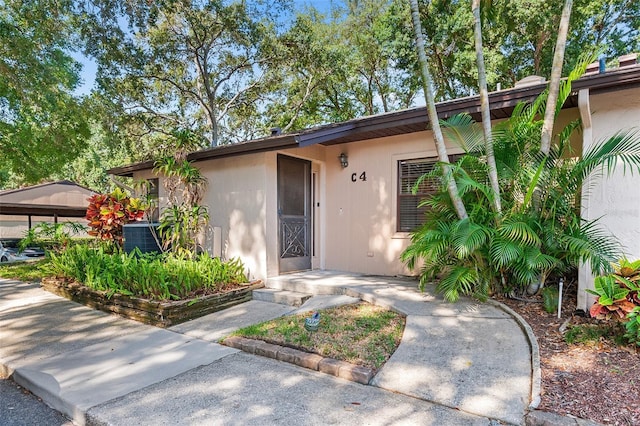 view of front of home featuring cooling unit and a carport