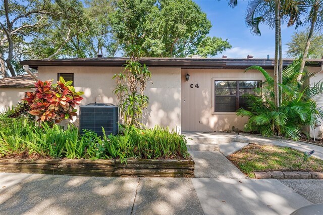 view of front of home featuring a patio area and central air condition unit