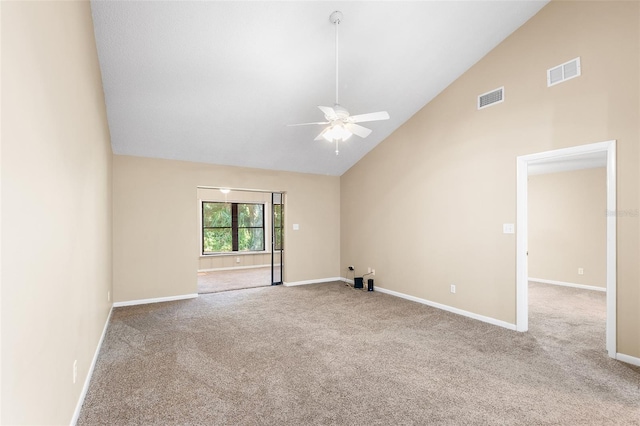 spare room featuring ceiling fan, light colored carpet, and high vaulted ceiling