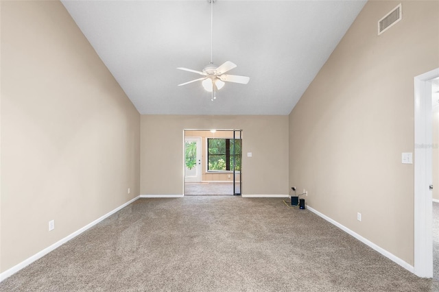 carpeted spare room featuring high vaulted ceiling and ceiling fan