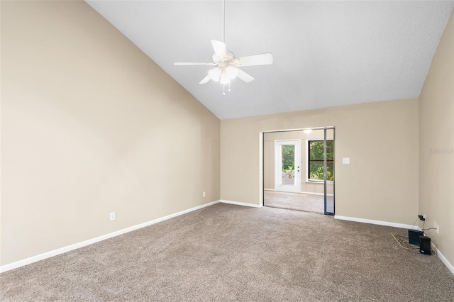 carpeted spare room featuring ceiling fan and high vaulted ceiling