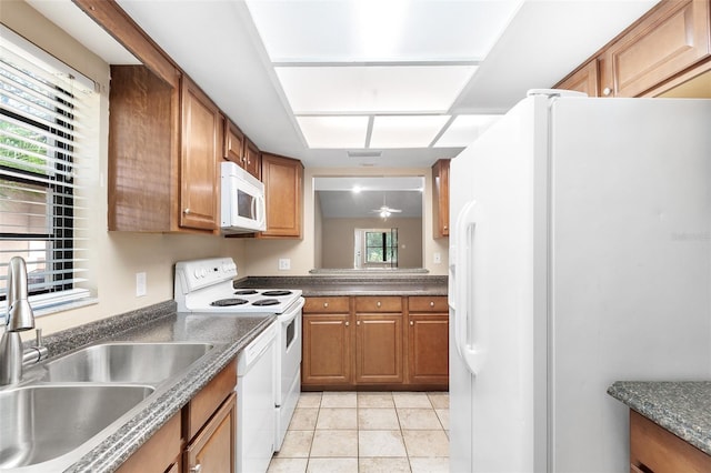 kitchen featuring sink, white appliances, light tile patterned floors, and ceiling fan