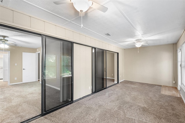 unfurnished sunroom with ceiling fan