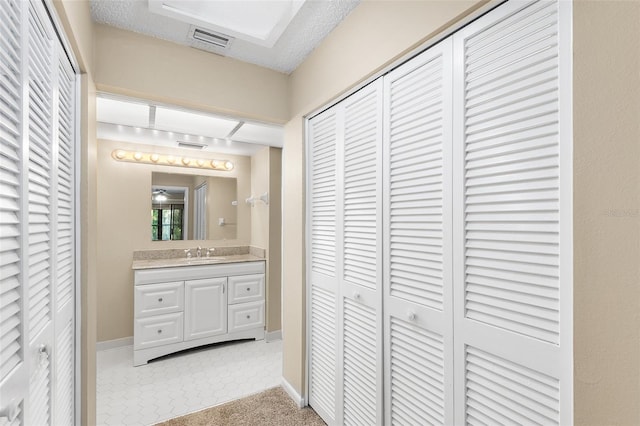 bathroom featuring vanity and a textured ceiling