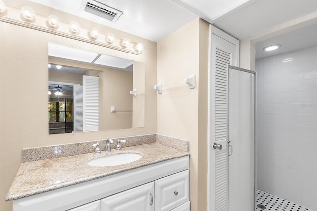 bathroom with vanity and a shower with shower door