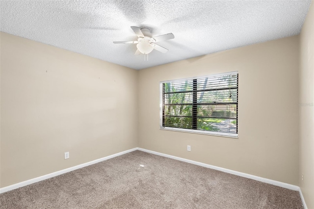 carpeted spare room with a textured ceiling and ceiling fan