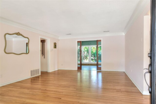 spare room with light hardwood / wood-style floors and ornamental molding