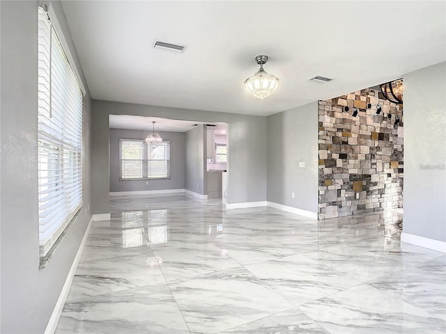 spare room featuring a notable chandelier