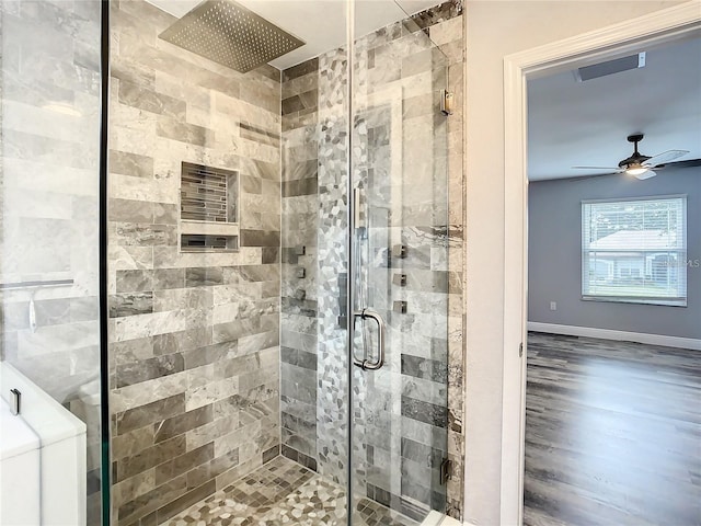 bathroom with ceiling fan and walk in shower